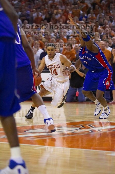 UT junior A.J. Abrams (#3, G) playing defense against a Kansas player.  The University of Texas (UT) Longhorns defeated the University of Kansas Jayhawks 72-69 in Austin, Texas on Monday, February 11, 2008.

Filename: SRM_20080211_2158161.jpg
Aperture: f/2.8
Shutter Speed: 1/640
Body: Canon EOS-1D Mark II
Lens: Canon EF 80-200mm f/2.8 L