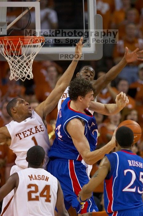 KU senior Sasha Kaun (#24, Center) attempts a shot as UT sophomore Justin Mason (#24, G), UT freshman Gary Johnson (#1, F), and UT sophomore Damion James (#5, G/F) block him.  The University of Texas (UT) Longhorns defeated the University of Kansas Jayhawks 72-69 in Austin, Texas on Monday, February 11, 2008.

Filename: SRM_20080211_2159057.jpg
Aperture: f/2.8
Shutter Speed: 1/640
Body: Canon EOS 20D
Lens: Canon EF 300mm f/2.8 L IS