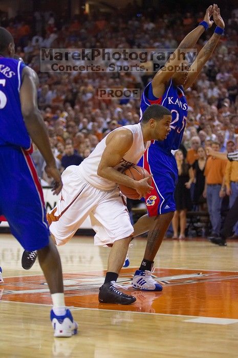 UT sophomore D.J. Augustin (#14, G) drives past KU junior Brandon Rush (#25, Guard) in the Kansas basketball game.  The University of Texas (UT) Longhorns defeated the University of Kansas Jayhawks 72-69 in Austin, Texas on Monday, February 11, 2008.

Filename: SRM_20080211_2159203.jpg
Aperture: f/2.8
Shutter Speed: 1/640
Body: Canon EOS-1D Mark II
Lens: Canon EF 80-200mm f/2.8 L