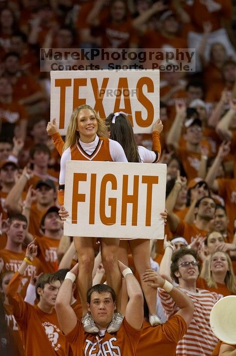 Cheerleaders.  The University of Texas (UT) Longhorns defeated the University of Kansas Jayhawks 72-69 in Austin, Texas on Monday, February 11, 2008.

Filename: SRM_20080211_2204106.jpg
Aperture: f/2.8
Shutter Speed: 1/640
Body: Canon EOS 20D
Lens: Canon EF 300mm f/2.8 L IS