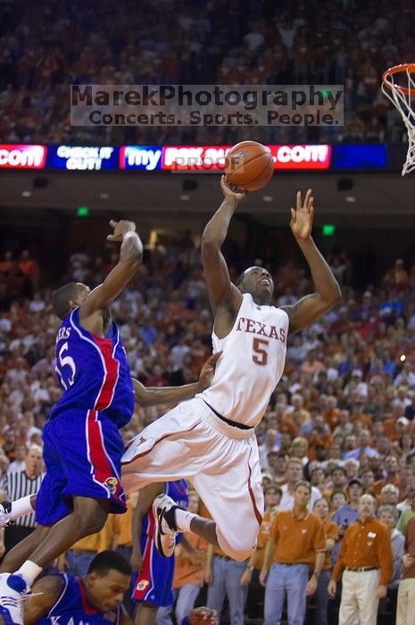 UT sophomore Damion James (#5, G/F) makes a shot as KU junior Mario Chalmers (#15, Guard) attempts to block.  The University of Texas (UT) Longhorns defeated the University of Kansas Jayhawks 72-69 in Austin, Texas on Monday, February 11, 2008.

Filename: SRM_20080211_2209042.jpg
Aperture: f/2.8
Shutter Speed: 1/640
Body: Canon EOS-1D Mark II
Lens: Canon EF 80-200mm f/2.8 L