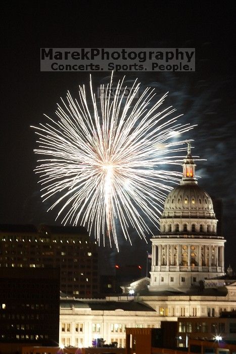 Austin Independence Day fireworks with the Capitol building, as viewed from atop the Manor Garage at The University of Texas at Austin.  The fireworks were launched from Auditorium Shores, downtown Austin, Friday, July 4, 2008.

Filename: SRM_20080704_2144180.jpg
Aperture: f/11.0
Shutter Speed: 2/1
Body: Canon EOS 20D
Lens: Canon EF 80-200mm f/2.8 L