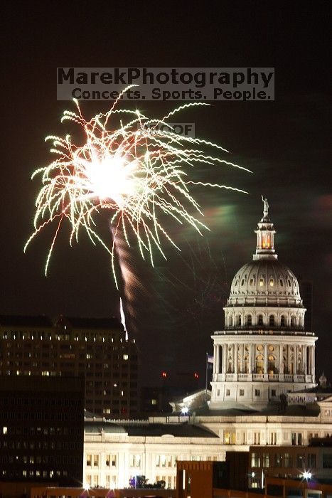 Austin Independence Day fireworks with the Capitol building, as viewed from atop the Manor Garage at The University of Texas at Austin.  The fireworks were launched from Auditorium Shores, downtown Austin, Friday, July 4, 2008.

Filename: SRM_20080704_2145328.jpg
Aperture: f/11.0
Shutter Speed: 5/1
Body: Canon EOS 20D
Lens: Canon EF 80-200mm f/2.8 L