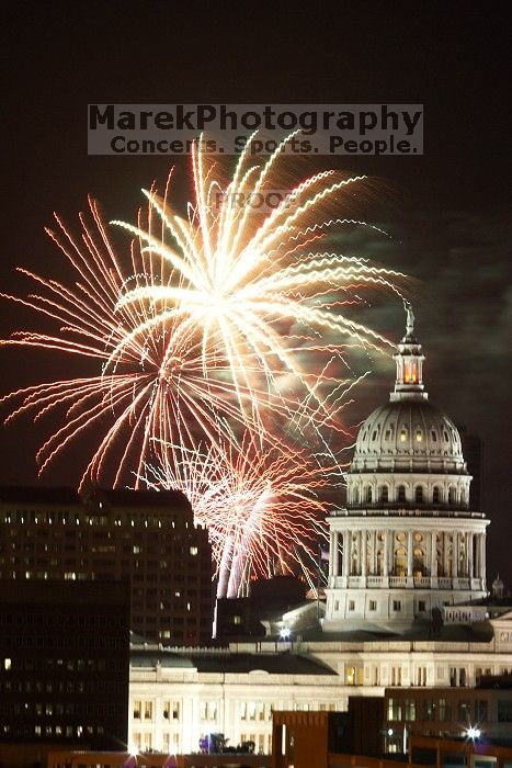 Austin Independence Day fireworks with the Capitol building, as viewed from atop the Manor Garage at The University of Texas at Austin.  The fireworks were launched from Auditorium Shores, downtown Austin, Friday, July 4, 2008.

Filename: SRM_20080704_2146121.jpg
Aperture: f/11.0
Shutter Speed: 5/1
Body: Canon EOS 20D
Lens: Canon EF 80-200mm f/2.8 L