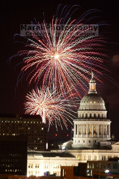 Austin Independence Day fireworks with the Capitol building, as viewed from atop the Manor Garage at The University of Texas at Austin.  The fireworks were launched from Auditorium Shores, downtown Austin, Friday, July 4, 2008.

Filename: SRM_20080704_2147467.jpg
Aperture: f/11.0
Shutter Speed: 5/1
Body: Canon EOS 20D
Lens: Canon EF 80-200mm f/2.8 L