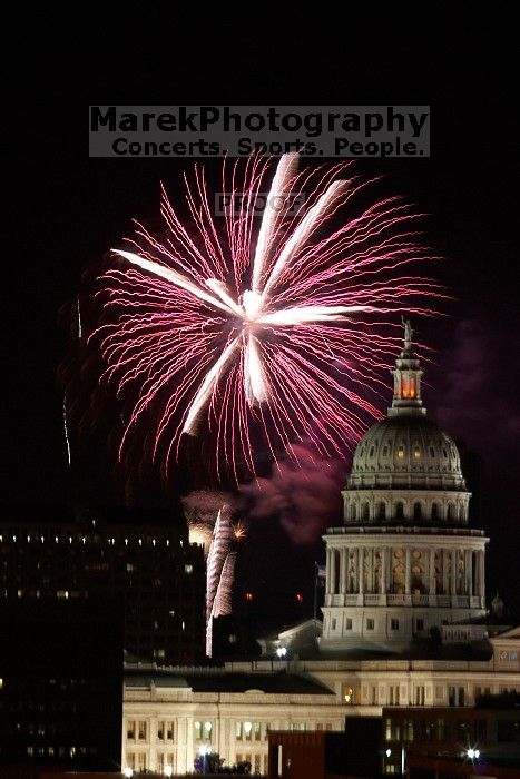 Austin Independence Day fireworks with the Capitol building, as viewed from atop the Manor Garage at The University of Texas at Austin.  The fireworks were launched from Auditorium Shores, downtown Austin, Friday, July 4, 2008.

Filename: SRM_20080704_2154165.jpg
Aperture: f/11.0
Shutter Speed: 2/1
Body: Canon EOS 20D
Lens: Canon EF 80-200mm f/2.8 L