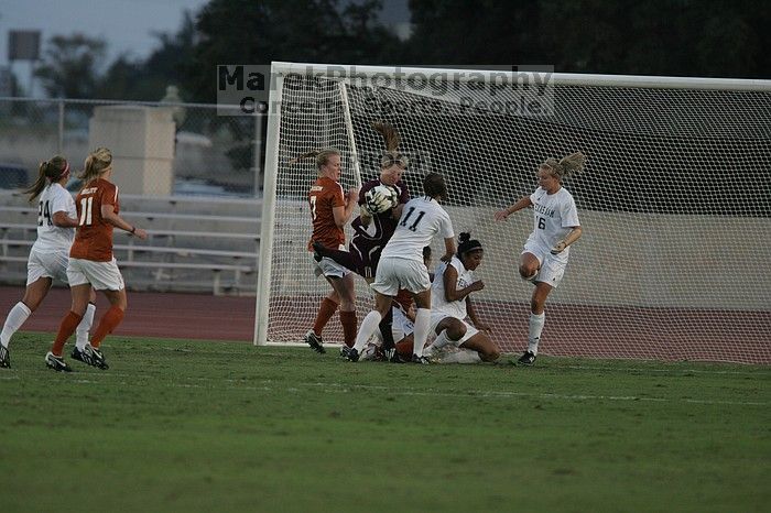 UT freshman Courtney Goodson (#7, Forward and Midfielder) loses the ball to the A&M goalkeeper.  The University of Texas women's soccer team tied 0-0 against the Texas A&M Aggies Friday night, September 27, 2008.

Filename: SRM_20080926_1910008.jpg
Aperture: f/4.0
Shutter Speed: 1/1000
Body: Canon EOS-1D Mark II
Lens: Canon EF 300mm f/2.8 L IS