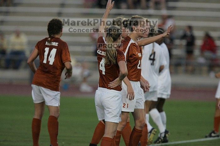 UT senior Kasey Moore (#14, Defender), UT senior Jill Gilbeau (#4, Defender and Midfielder), and UT junior Emily Anderson (#21, Forward) form a wall in front of a free kick.  The University of Texas women's soccer team tied 0-0 against the Texas A&M Aggies Friday night, September 27, 2008.

Filename: SRM_20080926_1917369.jpg
Aperture: f/4.0
Shutter Speed: 1/640
Body: Canon EOS-1D Mark II
Lens: Canon EF 300mm f/2.8 L IS