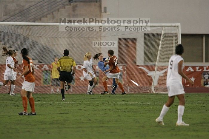 UT freshman Amanda Lisberger (#13, Midfielder) and UT senior Kasey Moore (#14, Defender) watch as UT senior Dianna Pfenninger (#8, Goalkeeper) catches a shot on goal.  The University of Texas women's soccer team tied 0-0 against the Texas A&M Aggies Friday night, September 27, 2008.

Filename: SRM_20080926_1928583.jpg
Aperture: f/4.0
Shutter Speed: 1/500
Body: Canon EOS-1D Mark II
Lens: Canon EF 300mm f/2.8 L IS