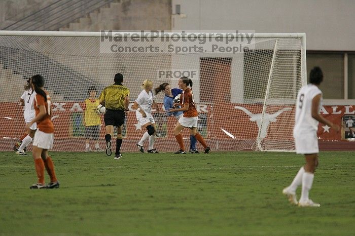 UT freshman Amanda Lisberger (#13, Midfielder) and UT senior Kasey Moore (#14, Defender) watch as UT senior Dianna Pfenninger (#8, Goalkeeper) catches a shot on goal.  The University of Texas women's soccer team tied 0-0 against the Texas A&M Aggies Friday night, September 27, 2008.

Filename: SRM_20080926_1928584.jpg
Aperture: f/4.0
Shutter Speed: 1/400
Body: Canon EOS-1D Mark II
Lens: Canon EF 300mm f/2.8 L IS