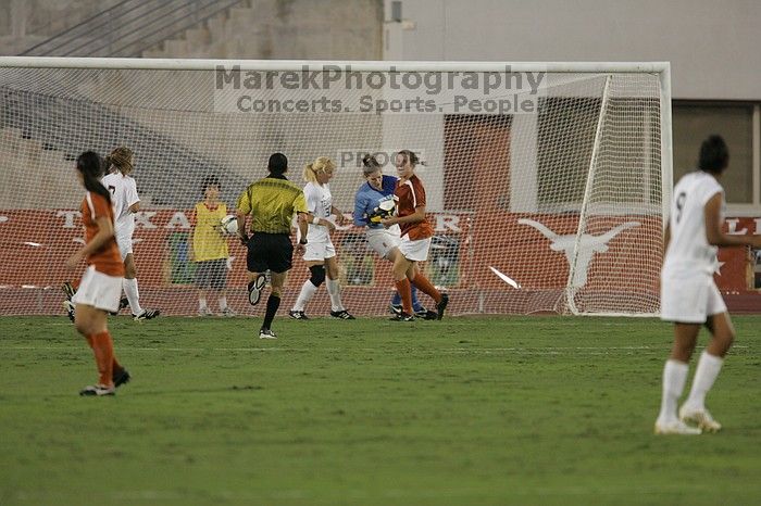 UT freshman Amanda Lisberger (#13, Midfielder) and UT senior Kasey Moore (#14, Defender) watch as UT senior Dianna Pfenninger (#8, Goalkeeper) catches a shot on goal.  The University of Texas women's soccer team tied 0-0 against the Texas A&M Aggies Friday night, September 27, 2008.

Filename: SRM_20080926_1929005.jpg
Aperture: f/4.0
Shutter Speed: 1/400
Body: Canon EOS-1D Mark II
Lens: Canon EF 300mm f/2.8 L IS