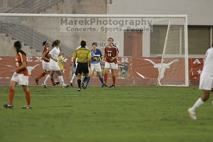 UT freshman Amanda Lisberger (#13, Midfielder) and UT senior Kasey Moore (#14, Defender) watch as UT senior Dianna Pfenninger (#8, Goalkeeper) catches a shot on goal.  The University of Texas women's soccer team tied 0-0 against the Texas A&M Aggies Friday night, September 27, 2008.

Filename: SRM_20080926_1929006.jpg
Aperture: f/4.0
Shutter Speed: 1/400
Body: Canon EOS-1D Mark II
Lens: Canon EF 300mm f/2.8 L IS