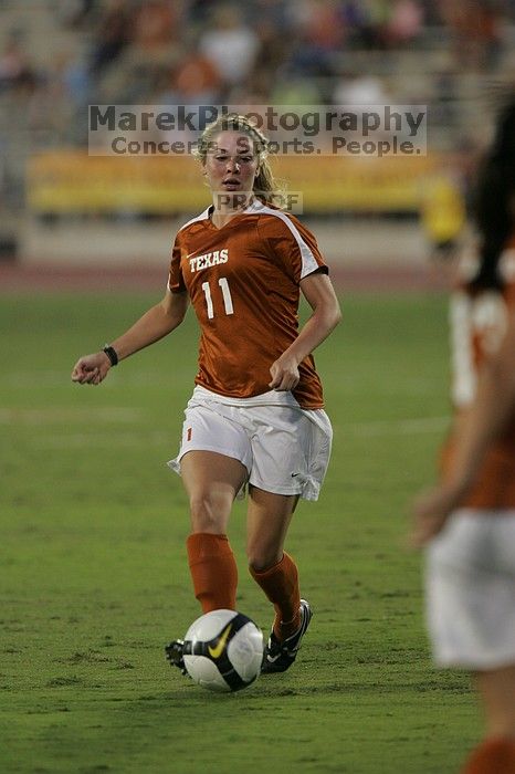 UT sophomore Niki Arlitt (#11, Forward) passes the ball to UT freshman Amanda Lisberger (#13, Midfielder).   The University of Texas women's soccer team tied 0-0 against the Texas A&M Aggies Friday night, September 27, 2008.

Filename: SRM_20080926_1929404.jpg
Aperture: f/4.0
Shutter Speed: 1/400
Body: Canon EOS-1D Mark II
Lens: Canon EF 300mm f/2.8 L IS