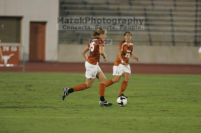 UT freshman Kylie Doniak (#15, Midfielder) takes the ball downfield as UT senior Kasey Moore (#14, Defender) and UT senior Courtney Gaines (#23, Midfielder) watch.  The University of Texas women's soccer team tied 0-0 against the Texas A&M Aggies Friday night, September 27, 2008.

Filename: SRM_20080926_1934165.jpg
Aperture: f/4.0
Shutter Speed: 1/400
Body: Canon EOS-1D Mark II
Lens: Canon EF 300mm f/2.8 L IS