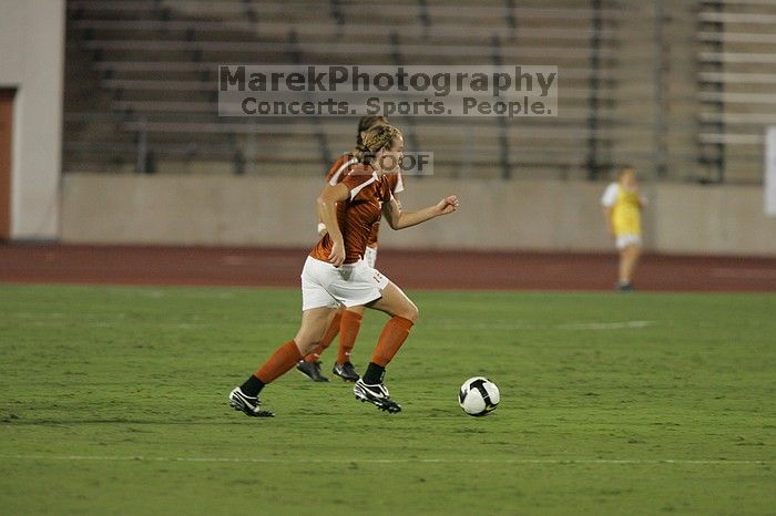 UT freshman Kylie Doniak (#15, Midfielder) takes the ball downfield as UT senior Kasey Moore (#14, Defender) and UT senior Courtney Gaines (#23, Midfielder) watch.  The University of Texas women's soccer team tied 0-0 against the Texas A&M Aggies Friday night, September 27, 2008.

Filename: SRM_20080926_1934166.jpg
Aperture: f/4.0
Shutter Speed: 1/400
Body: Canon EOS-1D Mark II
Lens: Canon EF 300mm f/2.8 L IS