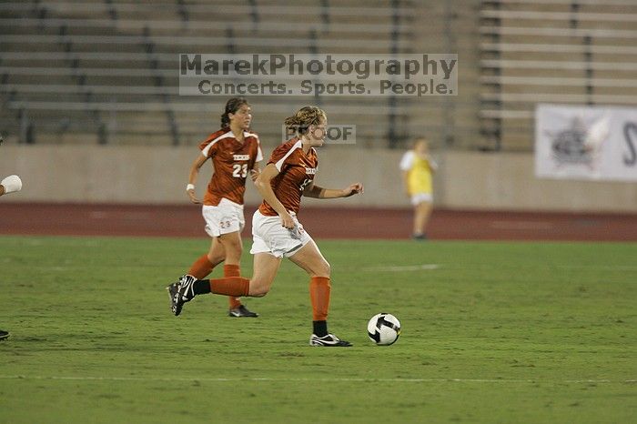 UT freshman Kylie Doniak (#15, Midfielder) takes the ball downfield as UT senior Kasey Moore (#14, Defender) and UT senior Courtney Gaines (#23, Midfielder) watch.  The University of Texas women's soccer team tied 0-0 against the Texas A&M Aggies Friday night, September 27, 2008.

Filename: SRM_20080926_1934167.jpg
Aperture: f/4.0
Shutter Speed: 1/400
Body: Canon EOS-1D Mark II
Lens: Canon EF 300mm f/2.8 L IS