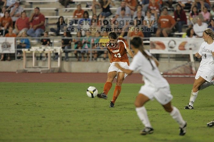 UT senior Courtney Gaines (#23, Midfielder) passes the ball.  The University of Texas women's soccer team tied 0-0 against the Texas A&M Aggies Friday night, September 27, 2008.

Filename: SRM_20080926_1935220.jpg
Aperture: f/4.0
Shutter Speed: 1/400
Body: Canon EOS-1D Mark II
Lens: Canon EF 300mm f/2.8 L IS