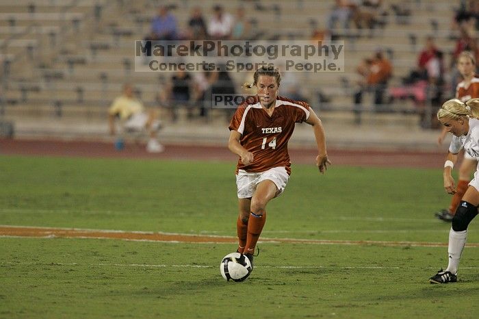 UT senior Kasey Moore (#14, Defender) brings the ball downfield.  The University of Texas women's soccer team tied 0-0 against the Texas A&M Aggies Friday night, September 27, 2008.

Filename: SRM_20080926_1935363.jpg
Aperture: f/4.0
Shutter Speed: 1/400
Body: Canon EOS-1D Mark II
Lens: Canon EF 300mm f/2.8 L IS