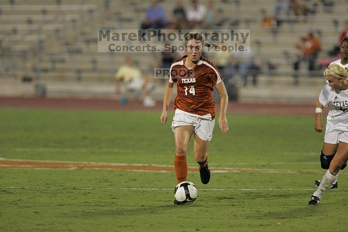 UT senior Kasey Moore (#14, Defender) brings the ball downfield.  The University of Texas women's soccer team tied 0-0 against the Texas A&M Aggies Friday night, September 27, 2008.

Filename: SRM_20080926_1935385.jpg
Aperture: f/4.0
Shutter Speed: 1/400
Body: Canon EOS-1D Mark II
Lens: Canon EF 300mm f/2.8 L IS