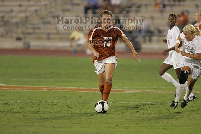 UT senior Kasey Moore (#14, Defender) brings the ball downfield.  The University of Texas women's soccer team tied 0-0 against the Texas A&M Aggies Friday night, September 27, 2008.

Filename: SRM_20080926_1935386.jpg
Aperture: f/4.0
Shutter Speed: 1/400
Body: Canon EOS-1D Mark II
Lens: Canon EF 300mm f/2.8 L IS