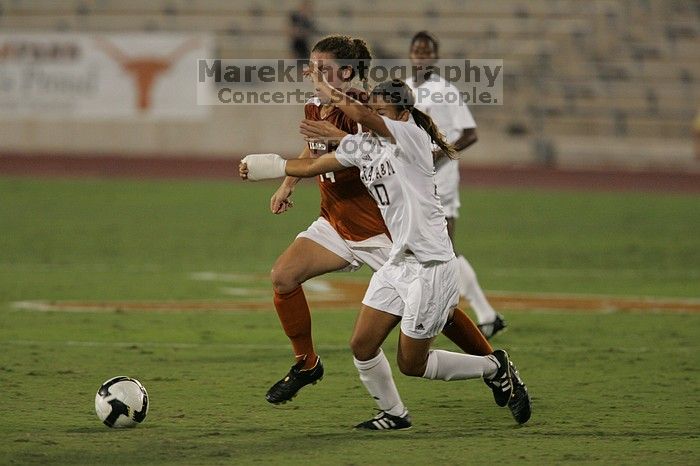 UT senior Kasey Moore (#14, Defender) brings the ball downfield.  The University of Texas women's soccer team tied 0-0 against the Texas A&M Aggies Friday night, September 27, 2008.

Filename: SRM_20080926_1935424.jpg
Aperture: f/4.0
Shutter Speed: 1/500
Body: Canon EOS-1D Mark II
Lens: Canon EF 300mm f/2.8 L IS