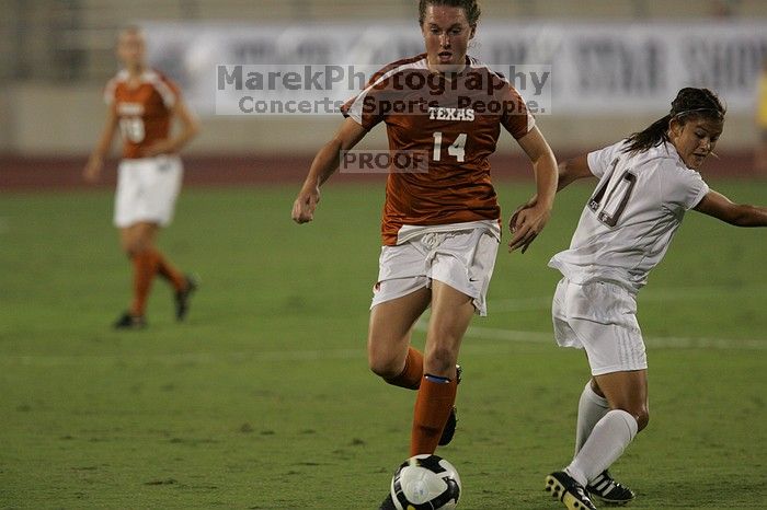 UT senior Kasey Moore (#14, Defender) brings the ball downfield.  The University of Texas women's soccer team tied 0-0 against the Texas A&M Aggies Friday night, September 27, 2008.

Filename: SRM_20080926_1935464.jpg
Aperture: f/4.0
Shutter Speed: 1/500
Body: Canon EOS-1D Mark II
Lens: Canon EF 300mm f/2.8 L IS