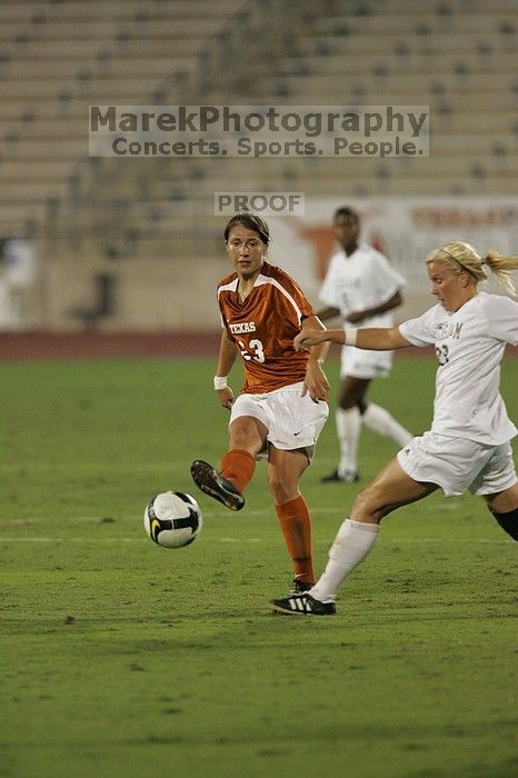 UT senior Courtney Gaines (#23, Midfielder) passes the ball.  The University of Texas women's soccer team tied 0-0 against the Texas A&M Aggies Friday night, September 27, 2008.

Filename: SRM_20080926_1936162.jpg
Aperture: f/4.0
Shutter Speed: 1/400
Body: Canon EOS-1D Mark II
Lens: Canon EF 300mm f/2.8 L IS