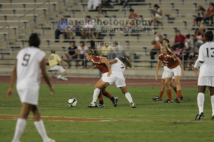 UT freshman Kylie Doniak (#15, Midfielder) tries to turn the ball as UT freshman Lucy Keith (#6, Midfielder) gives her support.  The University of Texas women's soccer team tied 0-0 against the Texas A&M Aggies Friday night, September 27, 2008.

Filename: SRM_20080926_1936580.jpg
Aperture: f/4.0
Shutter Speed: 1/500
Body: Canon EOS-1D Mark II
Lens: Canon EF 300mm f/2.8 L IS