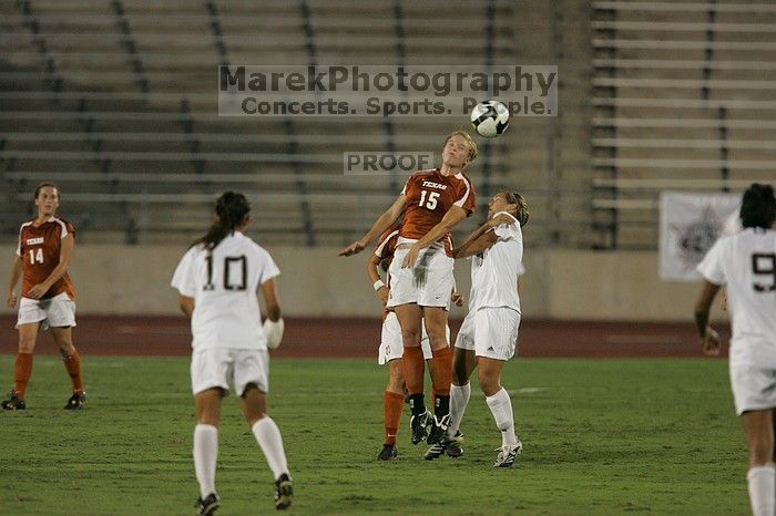 UT freshman Kylie Doniak (#15, Midfielder) heads the ball as UT senior Kasey Moore (#14, Defender) watches.  The University of Texas women's soccer team tied 0-0 against the Texas A&M Aggies Friday night, September 27, 2008.

Filename: SRM_20080926_1937409.jpg
Aperture: f/4.0
Shutter Speed: 1/500
Body: Canon EOS-1D Mark II
Lens: Canon EF 300mm f/2.8 L IS