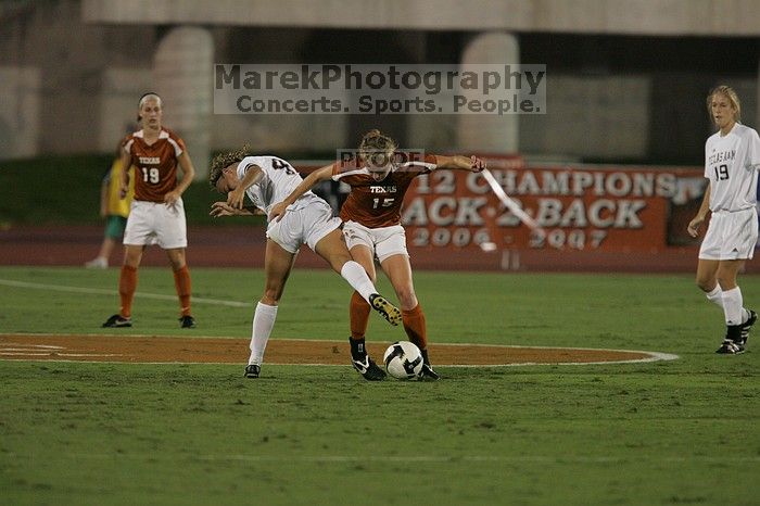 UT freshman Kylie Doniak (#15, Midfielder) tackles the ball as UT sophomore Erica Campanelli (#19, Defender) watches.  The University of Texas women's soccer team tied 0-0 against the Texas A&M Aggies Friday night, September 27, 2008.

Filename: SRM_20080926_1942066.jpg
Aperture: f/4.0
Shutter Speed: 1/500
Body: Canon EOS-1D Mark II
Lens: Canon EF 300mm f/2.8 L IS