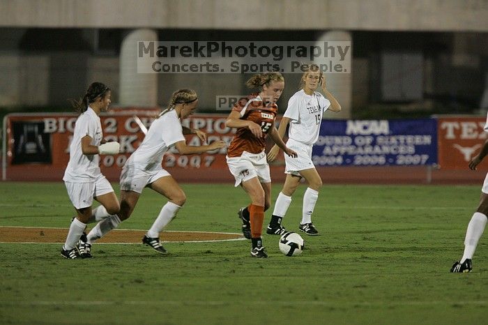 UT freshman Kylie Doniak (#15, Midfielder) tackles the ball as UT sophomore Erica Campanelli (#19, Defender) watches.  The University of Texas women's soccer team tied 0-0 against the Texas A&M Aggies Friday night, September 27, 2008.

Filename: SRM_20080926_1942103.jpg
Aperture: f/4.0
Shutter Speed: 1/500
Body: Canon EOS-1D Mark II
Lens: Canon EF 300mm f/2.8 L IS