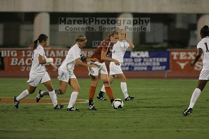 UT freshman Kylie Doniak (#15, Midfielder) tackles the ball as UT sophomore Erica Campanelli (#19, Defender) watches.  The University of Texas women's soccer team tied 0-0 against the Texas A&M Aggies Friday night, September 27, 2008.

Filename: SRM_20080926_1942104.jpg
Aperture: f/4.0
Shutter Speed: 1/500
Body: Canon EOS-1D Mark II
Lens: Canon EF 300mm f/2.8 L IS