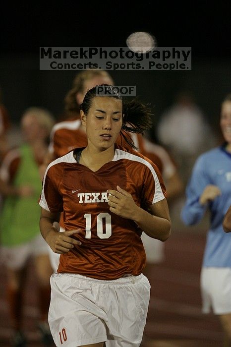 UT senior Stephanie Logterman (#10, Defender) running back to the team benches before the second half.  The University of Texas women's soccer team tied 0-0 against the Texas A&M Aggies Friday night, September 27, 2008.

Filename: SRM_20080926_2000442.jpg
Aperture: f/2.8
Shutter Speed: 1/500
Body: Canon EOS-1D Mark II
Lens: Canon EF 300mm f/2.8 L IS