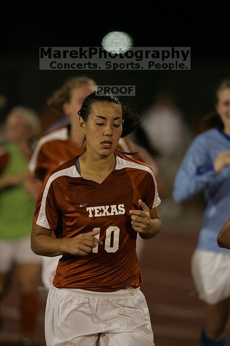 UT senior Stephanie Logterman (#10, Defender) running back to the team benches before the second half.  The University of Texas women's soccer team tied 0-0 against the Texas A&M Aggies Friday night, September 27, 2008.

Filename: SRM_20080926_2000443.jpg
Aperture: f/2.8
Shutter Speed: 1/500
Body: Canon EOS-1D Mark II
Lens: Canon EF 300mm f/2.8 L IS