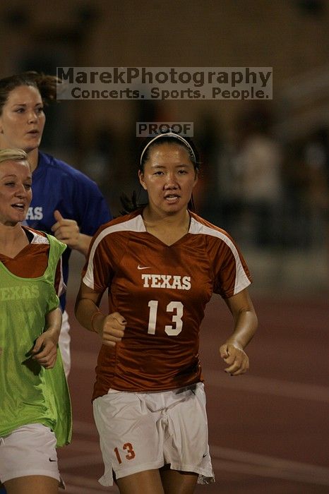 UT freshman Amanda Lisberger (#13, Midfielder) running back to the team benches before the second half.  The University of Texas women's soccer team tied 0-0 against the Texas A&M Aggies Friday night, September 27, 2008.

Filename: SRM_20080926_2000468.jpg
Aperture: f/2.8
Shutter Speed: 1/500
Body: Canon EOS-1D Mark II
Lens: Canon EF 300mm f/2.8 L IS