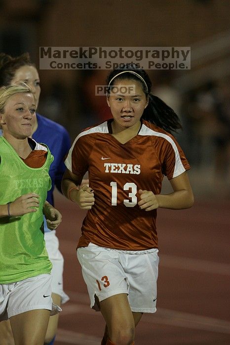 UT freshman Amanda Lisberger (#13, Midfielder) running back to the team benches before the second half.  The University of Texas women's soccer team tied 0-0 against the Texas A&M Aggies Friday night, September 27, 2008.

Filename: SRM_20080926_2000469.jpg
Aperture: f/2.8
Shutter Speed: 1/500
Body: Canon EOS-1D Mark II
Lens: Canon EF 300mm f/2.8 L IS