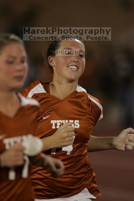 UT senior Kasey Moore (#14, Defender) running back to the team benches before the second half.  The University of Texas women's soccer team tied 0-0 against the Texas A&M Aggies Friday night, September 27, 2008.

Filename: SRM_20080926_2000525.jpg
Aperture: f/2.8
Shutter Speed: 1/500
Body: Canon EOS-1D Mark II
Lens: Canon EF 300mm f/2.8 L IS