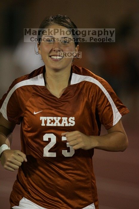 UT senior Courtney Gaines (#23, Midfielder) running back to the team benches before the second half.  The University of Texas women's soccer team tied 0-0 against the Texas A&M Aggies Friday night, September 27, 2008.

Filename: SRM_20080926_2000548.jpg
Aperture: f/2.8
Shutter Speed: 1/500
Body: Canon EOS-1D Mark II
Lens: Canon EF 300mm f/2.8 L IS