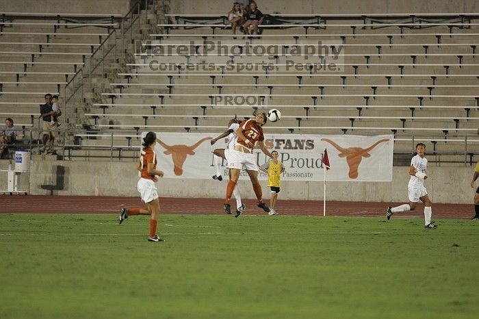 UT senior Courtney Gaines (#23, Midfielder) wins the header.  The University of Texas women's soccer team tied 0-0 against the Texas A&M Aggies Friday night, September 27, 2008.

Filename: SRM_20080926_2008528.jpg
Aperture: f/2.8
Shutter Speed: 1/500
Body: Canon EOS-1D Mark II
Lens: Canon EF 300mm f/2.8 L IS