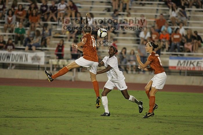 UT senior Kasey Moore (#14, Defender) and UT sophomore Erica Campanelli (#19, Defender).  The University of Texas women's soccer team tied 0-0 against the Texas A&M Aggies Friday night, September 27, 2008.

Filename: SRM_20080926_2009120.jpg
Aperture: f/2.8
Shutter Speed: 1/500
Body: Canon EOS-1D Mark II
Lens: Canon EF 300mm f/2.8 L IS