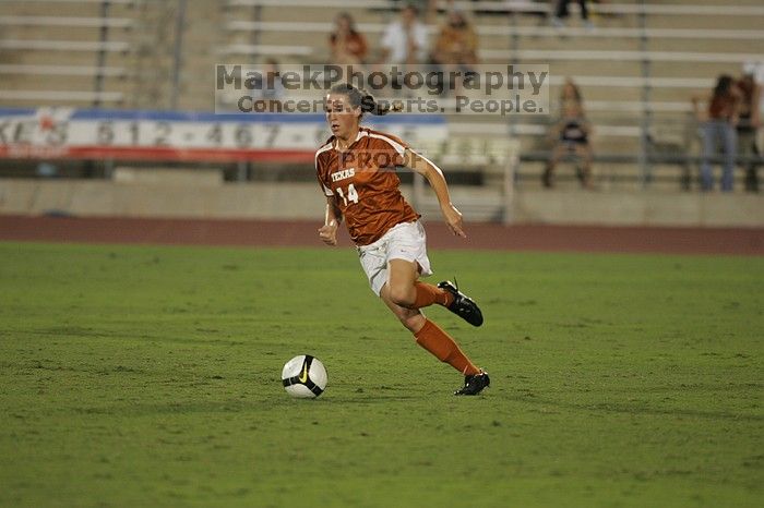 UT senior Kasey Moore (#14, Defender).  The University of Texas women's soccer team tied 0-0 against the Texas A&M Aggies Friday night, September 27, 2008.

Filename: SRM_20080926_2012100.jpg
Aperture: f/2.8
Shutter Speed: 1/500
Body: Canon EOS-1D Mark II
Lens: Canon EF 300mm f/2.8 L IS