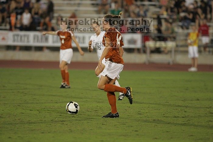 UT senior Kasey Moore (#14, Defender).  The University of Texas women's soccer team tied 0-0 against the Texas A&M Aggies Friday night, September 27, 2008.

Filename: SRM_20080926_2012127.jpg
Aperture: f/2.8
Shutter Speed: 1/500
Body: Canon EOS-1D Mark II
Lens: Canon EF 300mm f/2.8 L IS