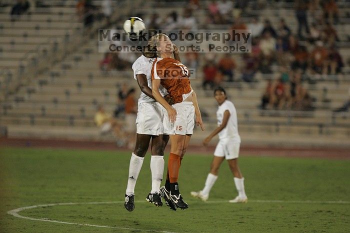 UT freshman Kylie Doniak (#15, Midfielder) misses the header.  The University of Texas women's soccer team tied 0-0 against the Texas A&M Aggies Friday night, September 27, 2008.

Filename: SRM_20080926_2013546.jpg
Aperture: f/2.8
Shutter Speed: 1/640
Body: Canon EOS-1D Mark II
Lens: Canon EF 300mm f/2.8 L IS