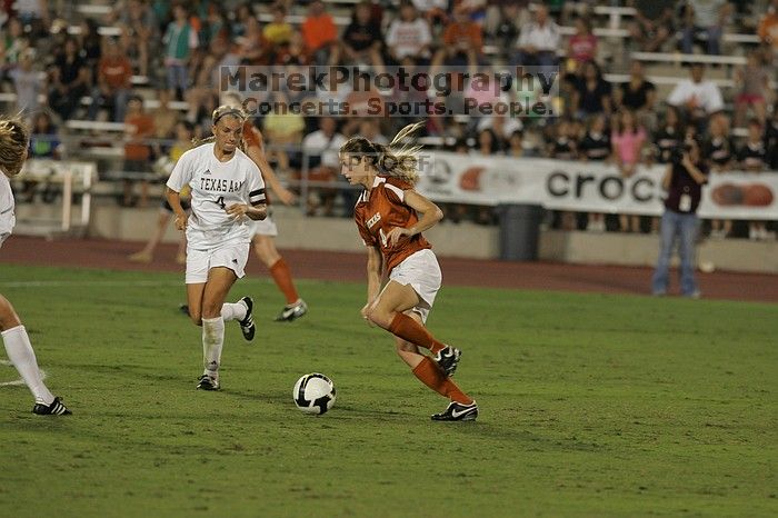 UT senior Jill Gilbeau (#4, Defender and Midfielder).  The University of Texas women's soccer team tied 0-0 against the Texas A&M Aggies Friday night, September 27, 2008.

Filename: SRM_20080926_2019561.jpg
Aperture: f/4.0
Shutter Speed: 1/400
Body: Canon EOS-1D Mark II
Lens: Canon EF 300mm f/2.8 L IS