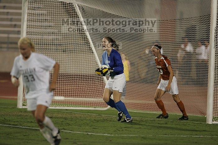 UT senior Dianna Pfenninger (#8, Goalkeeper) catches a shot on goal as UT sophomore Erica Campanelli (#19, Defender) watches.  The University of Texas women's soccer team tied 0-0 against the Texas A&M Aggies Friday night, September 27, 2008.

Filename: SRM_20080926_2029184.jpg
Aperture: f/2.8
Shutter Speed: 1/640
Body: Canon EOS-1D Mark II
Lens: Canon EF 300mm f/2.8 L IS