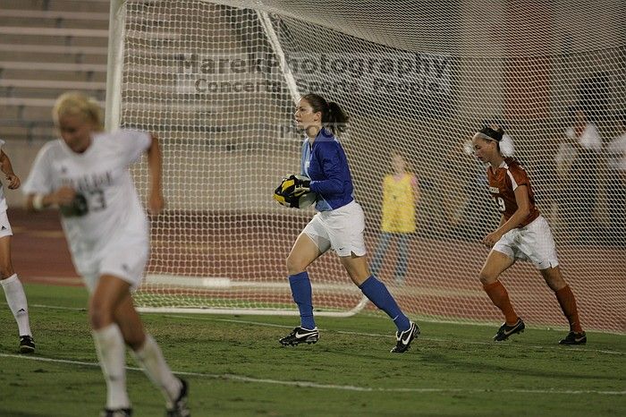 UT senior Dianna Pfenninger (#8, Goalkeeper) catches a shot on goal as UT sophomore Erica Campanelli (#19, Defender) watches.  The University of Texas women's soccer team tied 0-0 against the Texas A&M Aggies Friday night, September 27, 2008.

Filename: SRM_20080926_2029205.jpg
Aperture: f/2.8
Shutter Speed: 1/640
Body: Canon EOS-1D Mark II
Lens: Canon EF 300mm f/2.8 L IS