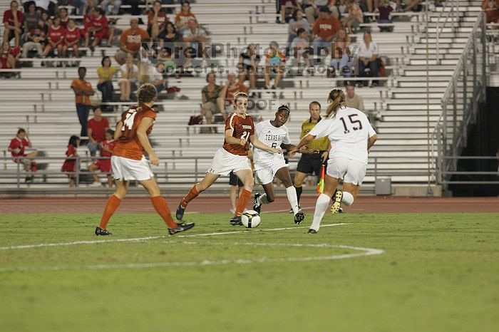 UT junior Emily Anderson (#21, Forward) passes the ball upfield with UT senior Kasey Moore (#14, Defender) watching.  The University of Texas women's soccer team tied 0-0 against the Texas A&M Aggies Friday night, September 27, 2008.

Filename: SRM_20080926_2039543.jpg
Aperture: f/4.0
Shutter Speed: 1/200
Body: Canon EOS-1D Mark II
Lens: Canon EF 300mm f/2.8 L IS