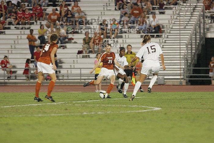 UT junior Emily Anderson (#21, Forward) passes the ball upfield with UT senior Kasey Moore (#14, Defender) watching.  The University of Texas women's soccer team tied 0-0 against the Texas A&M Aggies Friday night, September 27, 2008.

Filename: SRM_20080926_2039544.jpg
Aperture: f/4.0
Shutter Speed: 1/200
Body: Canon EOS-1D Mark II
Lens: Canon EF 300mm f/2.8 L IS