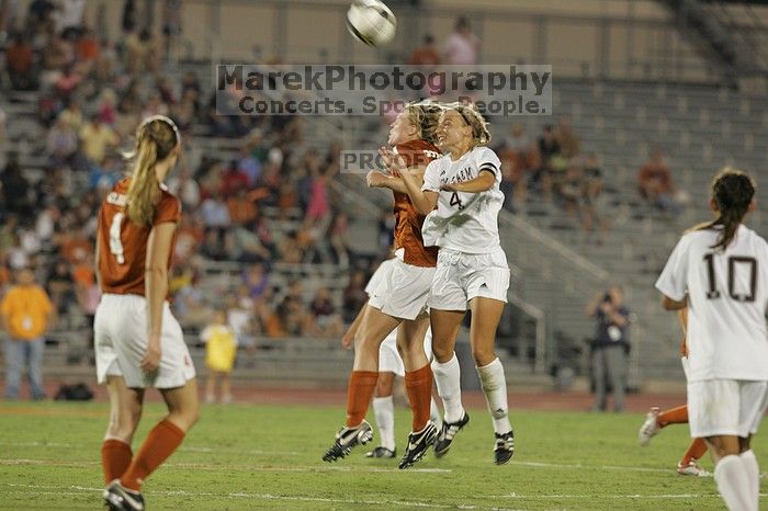 UT freshman Courtney Goodson (#7, Forward and Midfielder) fights for the header as UT senior Jill Gilbeau (#4, Defender and Midfielder) watches.  The University of Texas women's soccer team tied 0-0 against the Texas A&M Aggies Friday night, September 27, 2008.

Filename: SRM_20080926_2041120.jpg
Aperture: f/4.0
Shutter Speed: 1/200
Body: Canon EOS-1D Mark II
Lens: Canon EF 300mm f/2.8 L IS