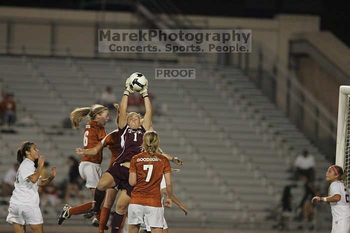 A&M goalkeeper catches another shot on goal as UT senior Kasey Moore (#14, Defender) and UT freshman Lucy Keith (#6, Midfielder) attempt the header and UT freshman Courtney Goodson (#7, Forward and Midfielder) watches.  The University of Texas women's soccer team tied 0-0 against the Texas A&M Aggies Friday night, September 27, 2008.

Filename: SRM_20080926_2049489.jpg
Aperture: f/2.8
Shutter Speed: 1/500
Body: Canon EOS-1D Mark II
Lens: Canon EF 300mm f/2.8 L IS